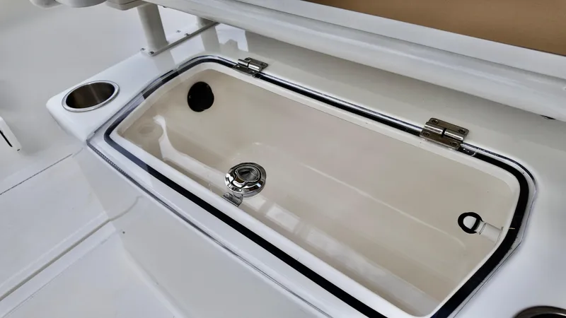 Slide: The Image of Livewell on 2025 Bayliner Trophy 24 CC boat, featuring a sleek design and stainless steel fittings. - 15