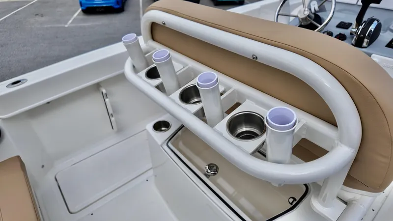 Slide: The Image of 2025 Bayliner Trophy 24 CC boat interior with rod holders and cup holders. - 16