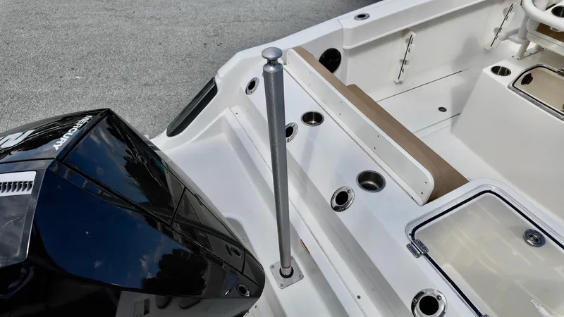 Slide: The Image of 2025 Bayliner Trophy 24 CC boat interior with Mercury engine, rod holders, and seating. - 20