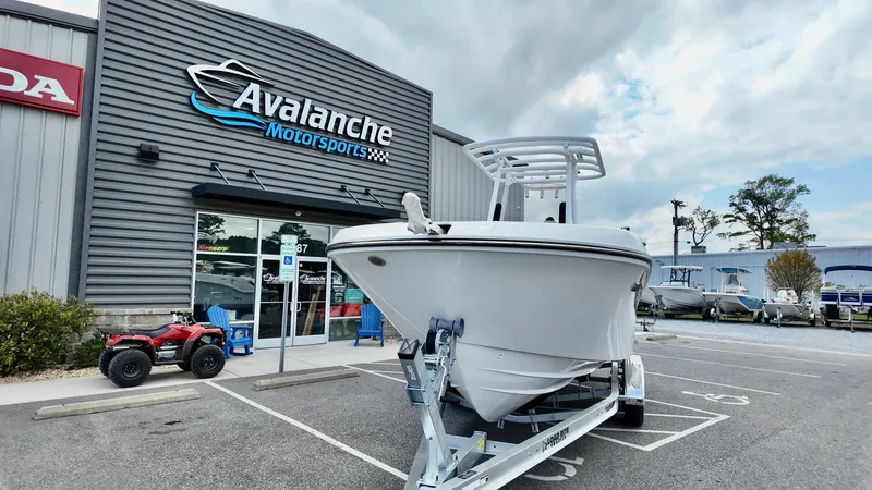 Slide: The Image of 2025 Bayliner Trophy 24 CC boat on trailer outside Avalanche Motorsports. - 3