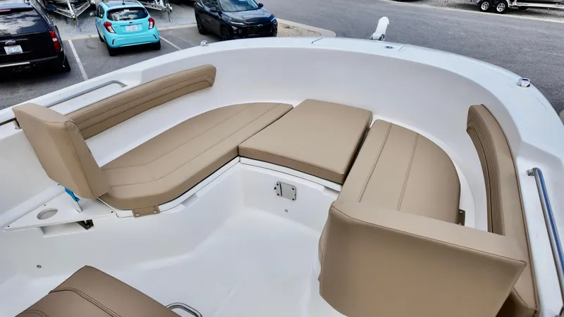 Slide: The Image of 2025 Bayliner Trophy 24 CC boat interior with tan cushioned seating. - 5