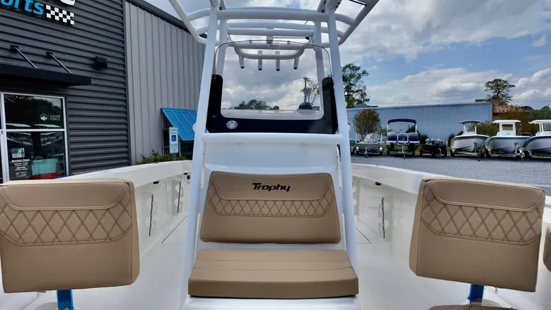 Slide: The Image of 2025 Bayliner Trophy 24 CC boat interior with tan seating and center console. - 6