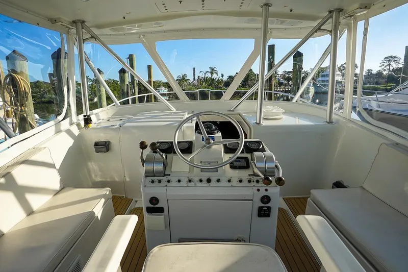Slide: The Image of 1997 Luhrs Tournament 320 Open helm with steering wheel and controls, featuring spacious seating. - 14