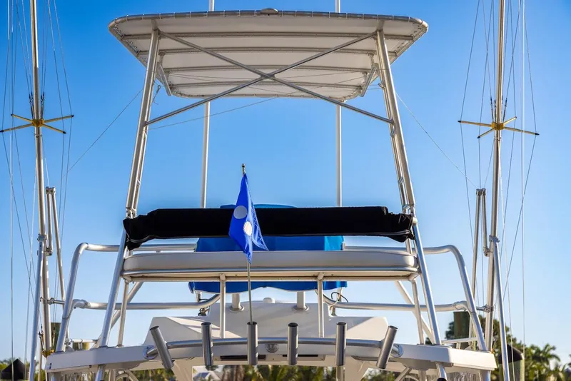 Slide: The Image of 1997 Luhrs Tournament 320 Open boat with tower and blue flag against clear sky. - 15