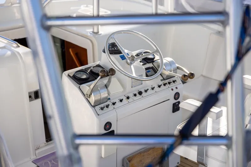 Slide: The Image of 1997 Luhrs Tournament 320 Open boat helm with steering wheel and controls. - 16