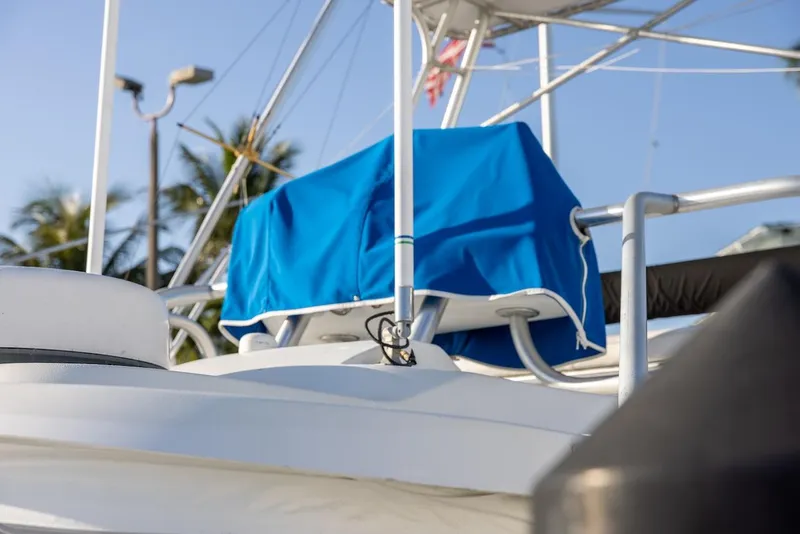 Slide: The Image of 1997 Luhrs Tournament 320 Open boat with blue cover, palm trees in background. - 18