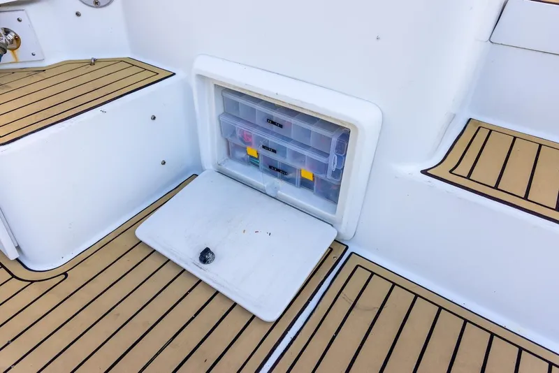 Slide: The Image of 1997 Luhrs Tournament 320 Open boat with tackle storage compartment and teak flooring. - 21