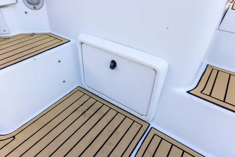 Slide: The Image of 1997 Luhrs Tournament 320 Open boat deck with storage compartment and teak flooring. - 22