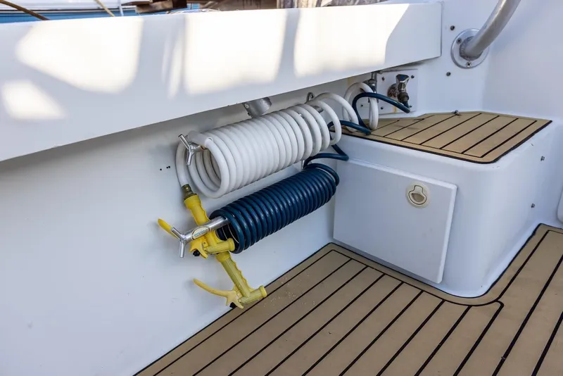 Slide: The Image of 1997 Luhrs Tournament 320 Open deck with coiled hoses and teak flooring. - 24