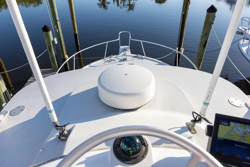 Slide: The Image of 1997 Luhrs Tournament 320 Open boat deck with navigation equipment, docked at a marina. - 27