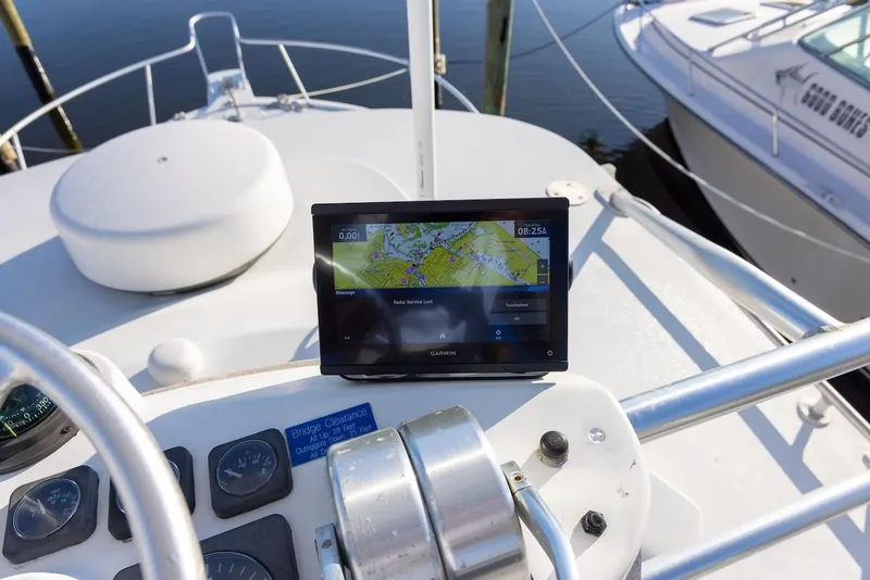 Slide: The Image of 1997 Luhrs Tournament 320 Open boat helm with navigation display and controls. - 28