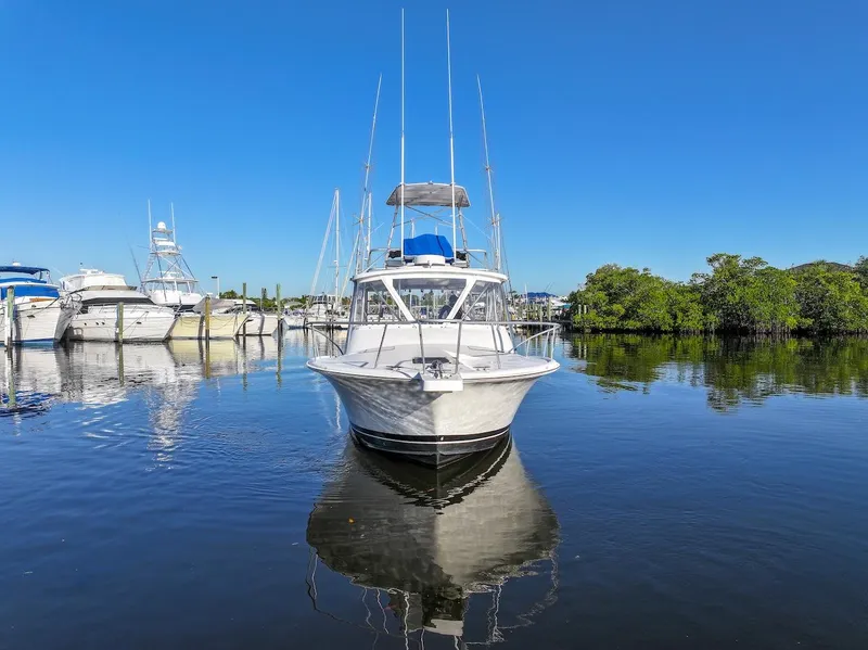 Slide: The Image of 1997 Luhrs Tournament 320 Open boat docked on calm water under clear blue sky. - 3