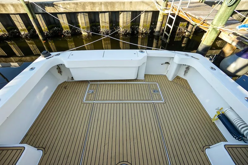 Slide: The Image of Spacious deck of 1997 Luhrs Tournament 320 Open boat, featuring teak flooring. - 30