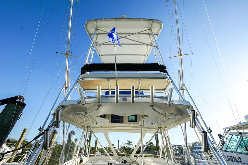Slide: The Image of 1997 Luhrs Tournament 320 Open boat with tower and blue flag against clear sky. - 32