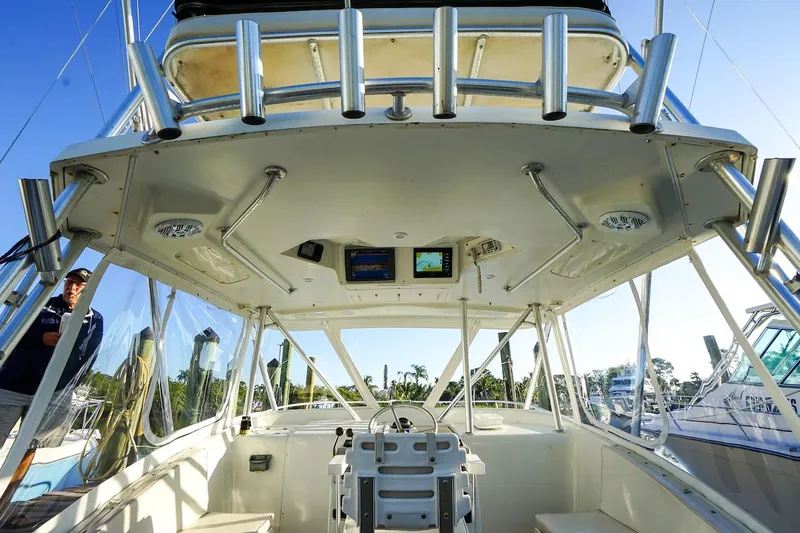 Slide: The Image of 1997 Luhrs Tournament 320 Open boat cockpit with fishing rod holders and navigation equipment. - 33