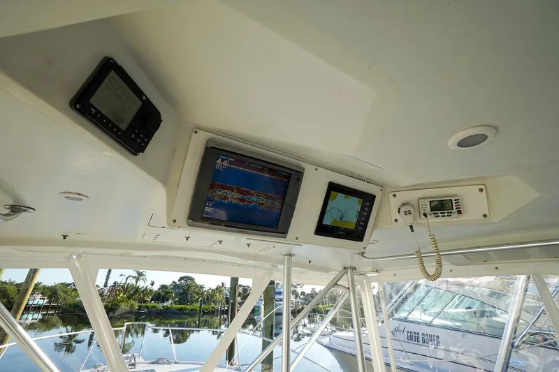 Slide: The Image of 1997 Luhrs Tournament 320 Open helm with navigation equipment and serene marina view. - 34