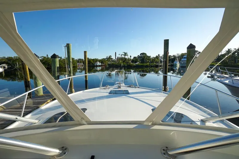Slide: The Image of 1997 Luhrs Tournament 320 Open yacht docked in a serene marina setting. - 36