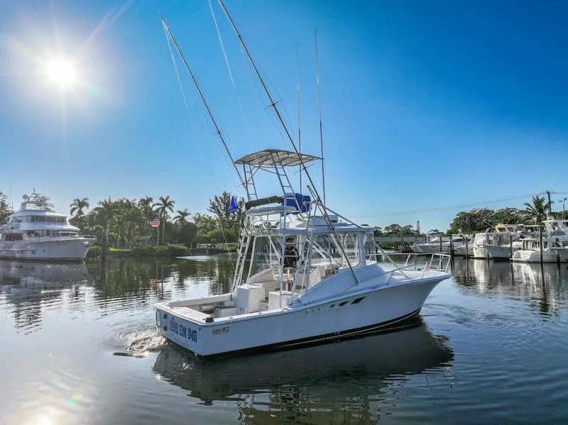 Slide: The Image of 1997 Luhrs Tournament 320 Open boat on calm water under clear blue sky. - 4