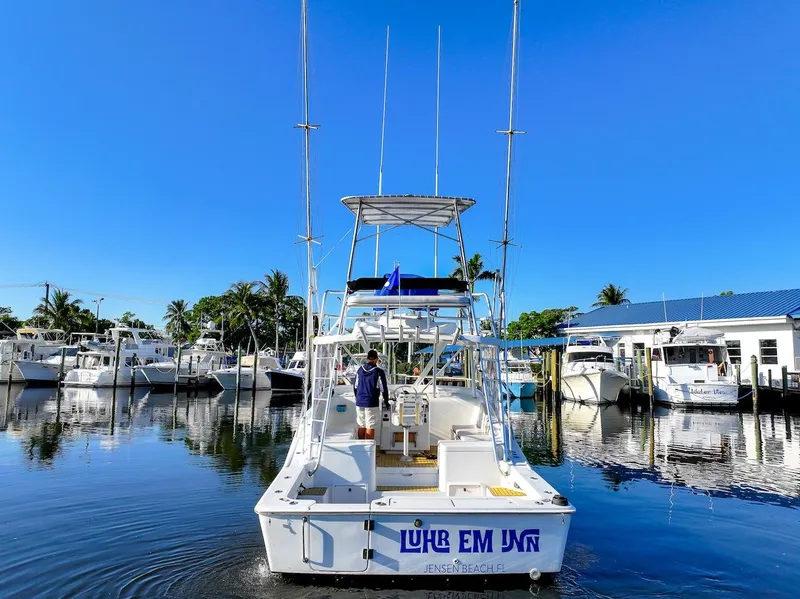 Slide: The Image of 1997 Luhrs Tournament 320 Open boat docked in a marina under clear blue skies. - 5