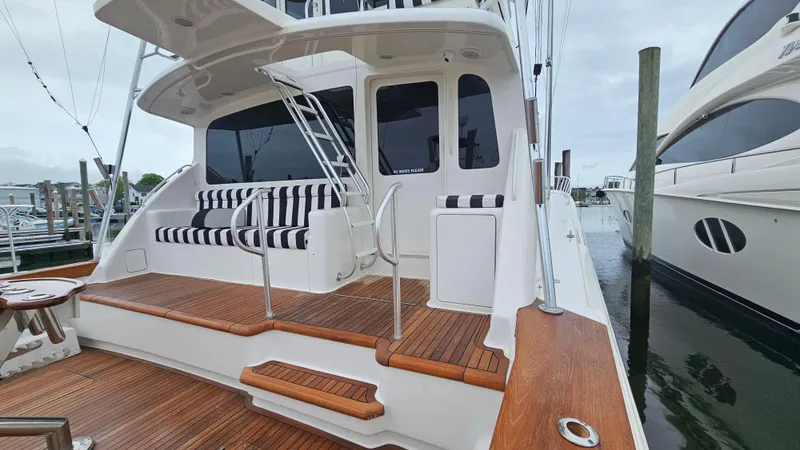 Slide: The Image of Ocean Yachts 2000 model 70 Super Sport with teak deck and striped seating at marina. - 12