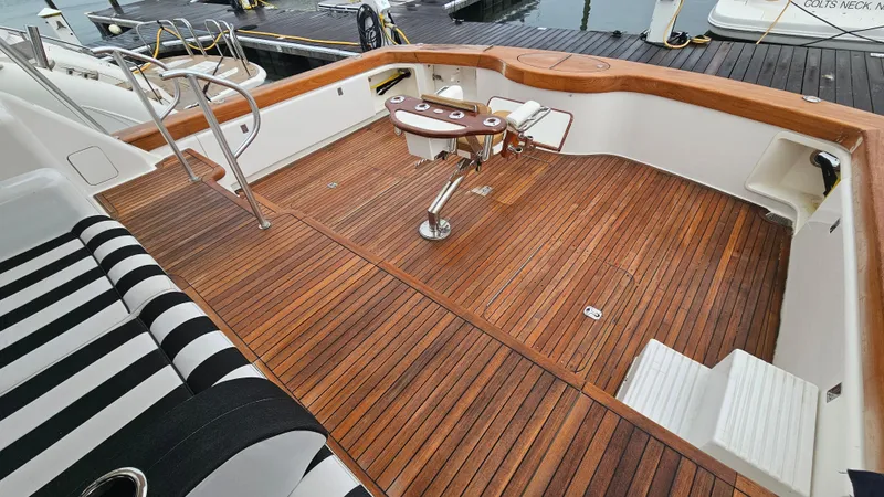 Slide: The Image of Luxurious 2000 Ocean Yachts 70 Super Sport with elegant teak deck and striped seating. - 15