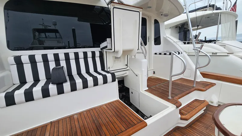 Slide: The Image of Luxury Ocean Yachts 70 Super Sport 2000 with striped seating and wooden deck. - 16