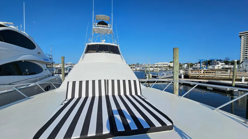 Slide: The Image of Ocean Yachts 70 Super Sport 2000 with striped deck cushions at marina. - 20