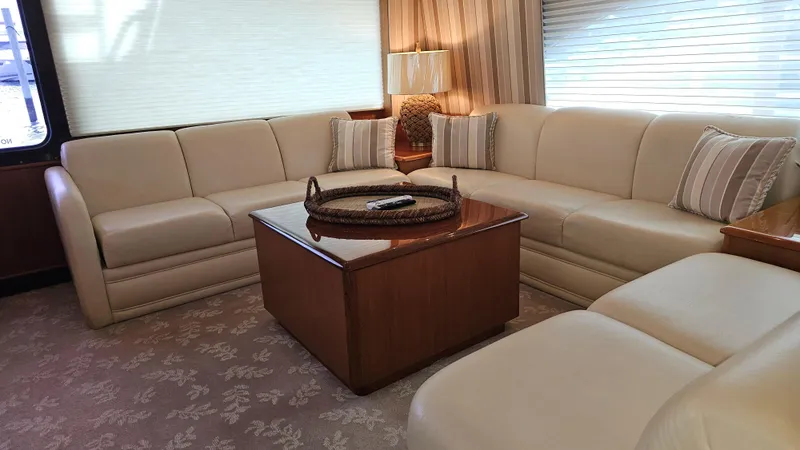 Slide: The Image of Luxurious interior of 2000 Ocean Yachts 70 Super Sport with beige seating and wooden table. - 28