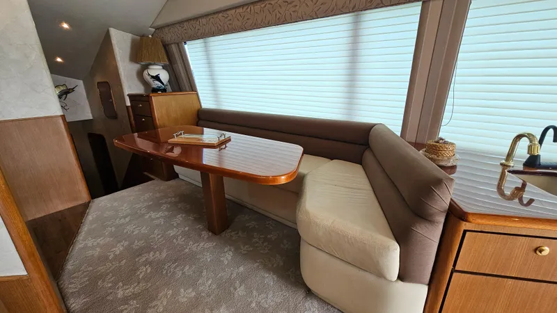Slide: The Image of Interior of 2000 Ocean Yachts 70 Super Sport with elegant seating and wooden table. - 31