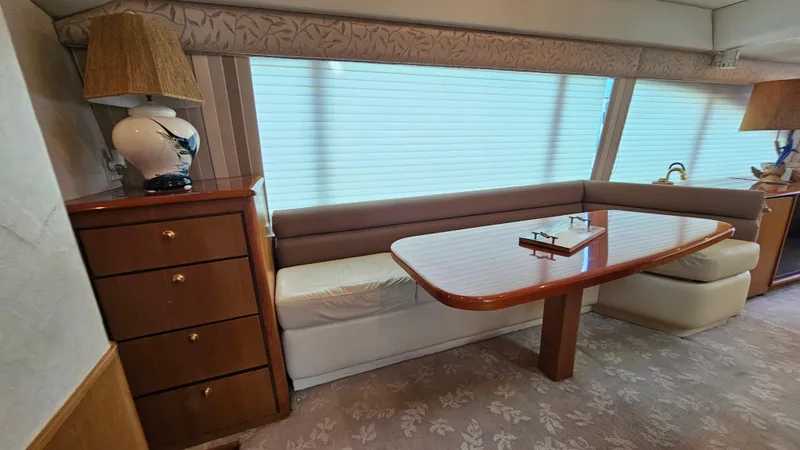 Slide: The Image of Interior of 2000 Ocean Yachts 70 Super Sport with elegant dining area and wooden cabinetry. - 32