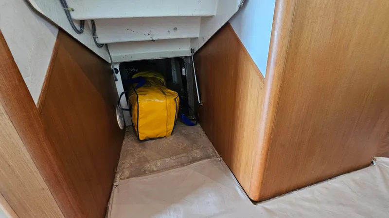 Slide: The Image of Interior storage space on a 2000 Ocean Yachts 70 Super Sport with a yellow bag. - 35