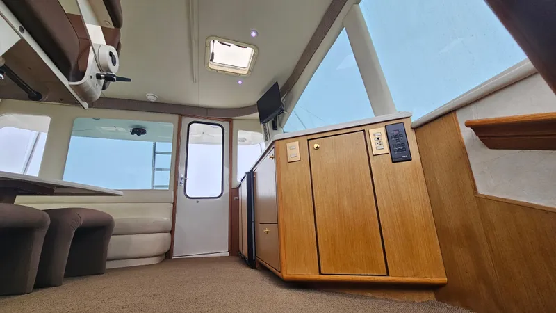 Slide: The Image of Interior of 2000 Ocean Yachts 70 Super Sport, featuring wood cabinetry and seating. - 37