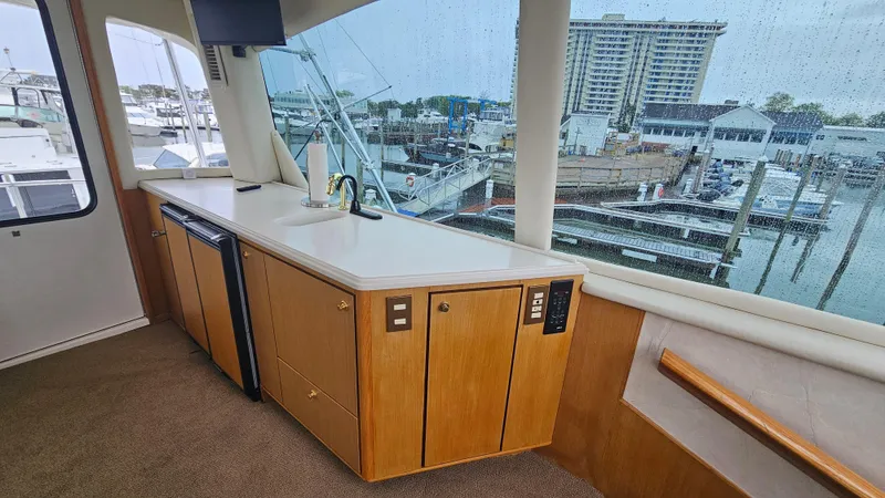Slide: The Image of Interior of 2000 Ocean Yachts 70 Super Sport with kitchenette and marina view. - 38