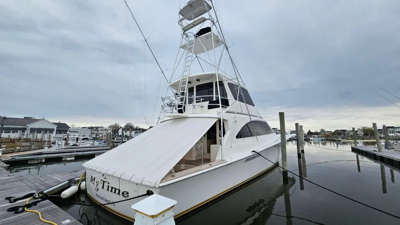 Slide: The Image of Ocean Yachts 2000 model 70 Super Sport docked at marina under cloudy sky. - 4