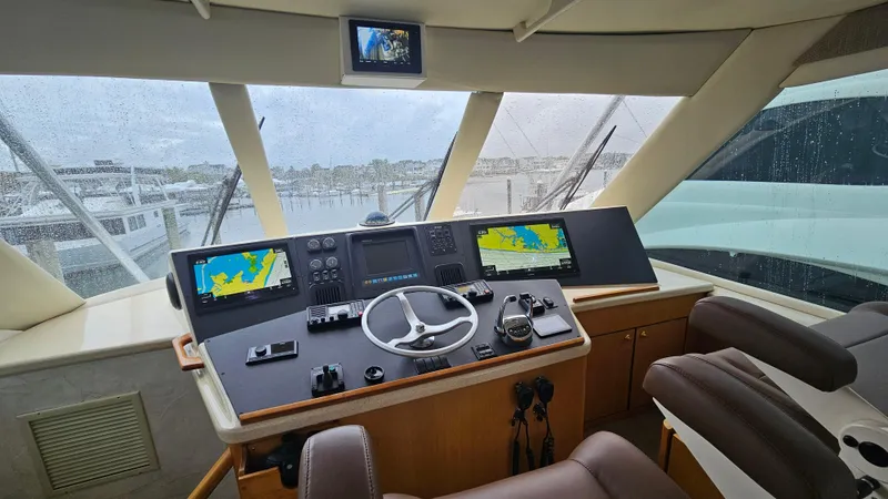 Slide: The Image of Cockpit of 2000 Ocean Yachts 70 Super Sport with navigation screens and steering wheel. - 44