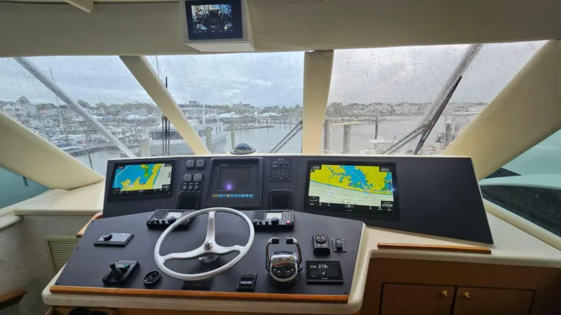 Slide: The Image of Cockpit of 2000 Ocean Yachts 70 Super Sport with navigation screens and steering wheel. - 45