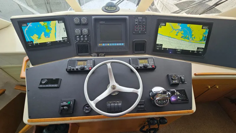 Slide: The Image of Helm of 2000 Ocean Yachts 70 Super Sport with navigation screens and controls. - 46