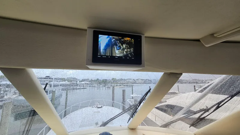 Slide: The Image of Cockpit view from a 2000 Ocean Yachts 70 Super Sport, featuring a monitor and marina. - 48