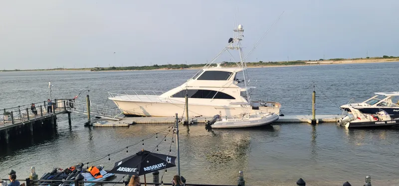 Slide: The Image of A 2000 Ocean Yachts 70 Super Sport docked at a marina on a calm day. - 5