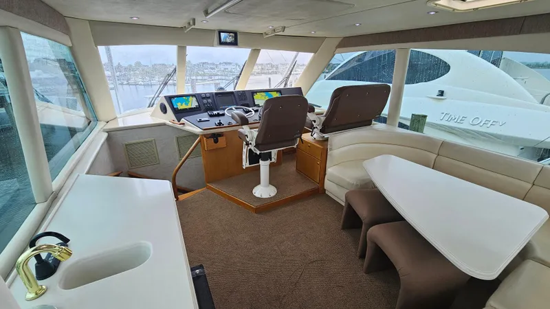 Slide: The Image of Interior of 2000 Ocean Yachts 70 Super Sport with helm, seating, and table. - 51