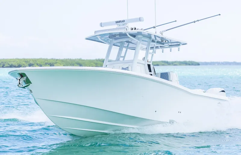 Slide: The Image of 2024 Invincible 33 Open Fisherman boat cruising on clear blue water. - 17