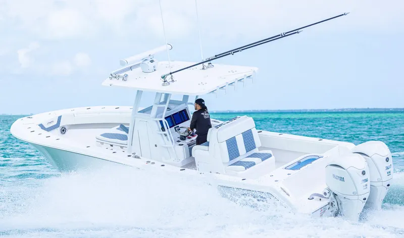 Slide: The Image of 2024 Invincible 33 Open Fisherman cruising on turquoise waters. - 18