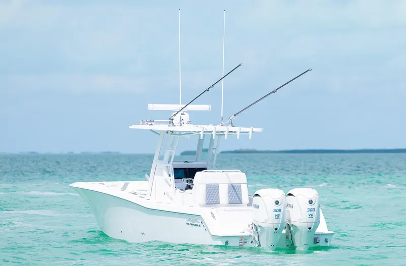 Slide: The Image of 2024 Invincible 33 Open Fisherman boat on clear turquoise water. - 21