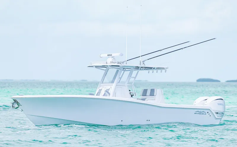 Slide: The Image of 2024 Invincible 33 Open Fisherman boat on turquoise water, side view. - 24
