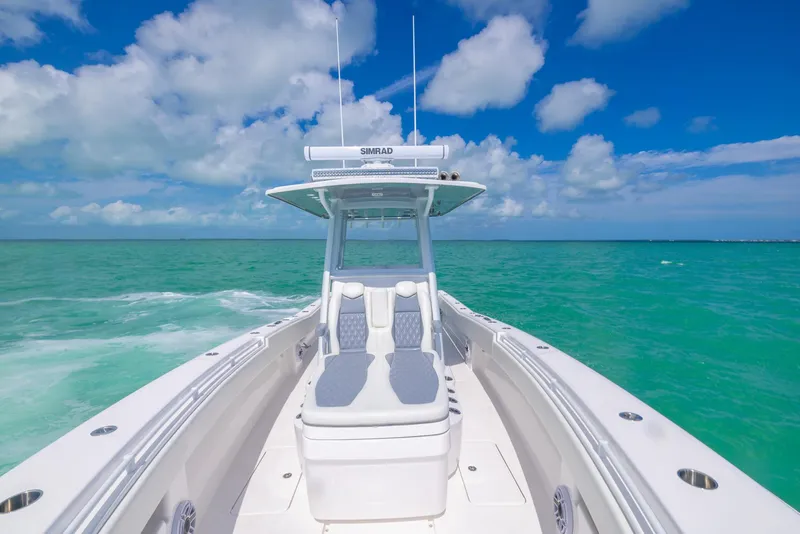 Slide: The Image of 2024 Invincible 33 Open Fisherman boat cruising on turquoise ocean under blue sky. - 29