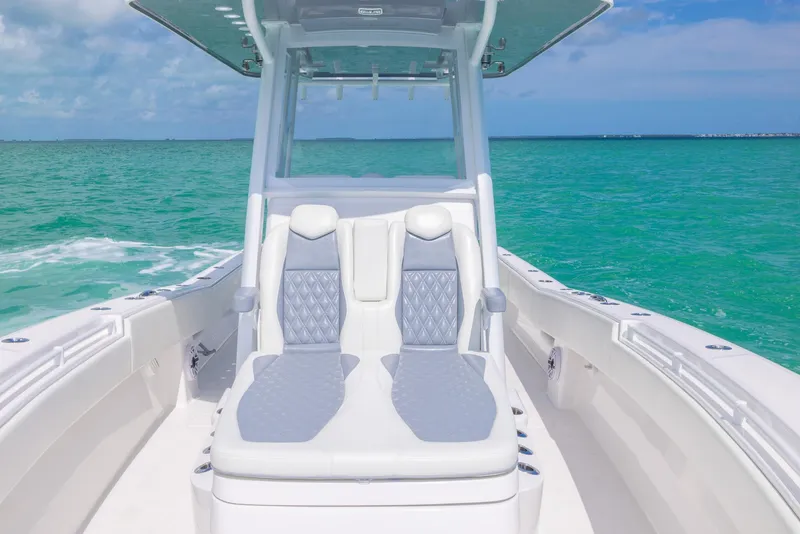 Slide: The Image of 2024 Invincible 33 Open Fisherman boat with luxurious seating on turquoise waters. - 30