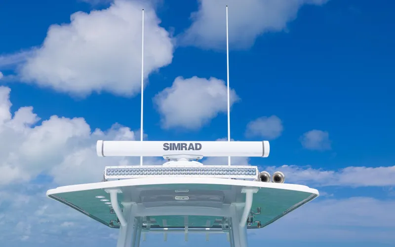 Slide: The Image of 2024 Invincible 33 Open Fisherman boat with Simrad radar against blue sky. - 31