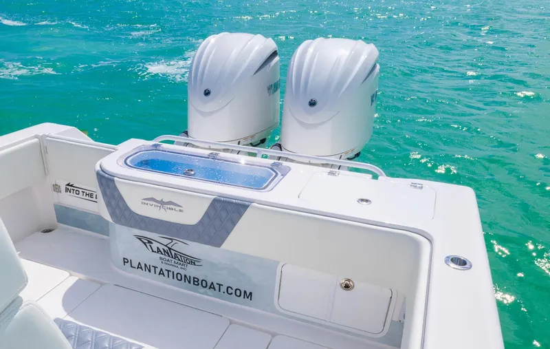 Slide: The Image of 2024 Invincible 33 Open Fisherman boat with dual engines on turquoise water. - 35