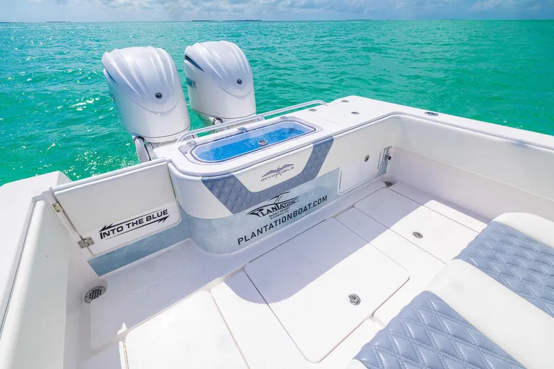 Slide: The Image of 2024 Invincible 33 Open Fisherman boat with twin engines on turquoise water. - 36