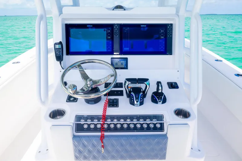 Slide: The Image of 2024 Invincible 33 Open Fisherman boat console with dual screens and steering wheel. - 40